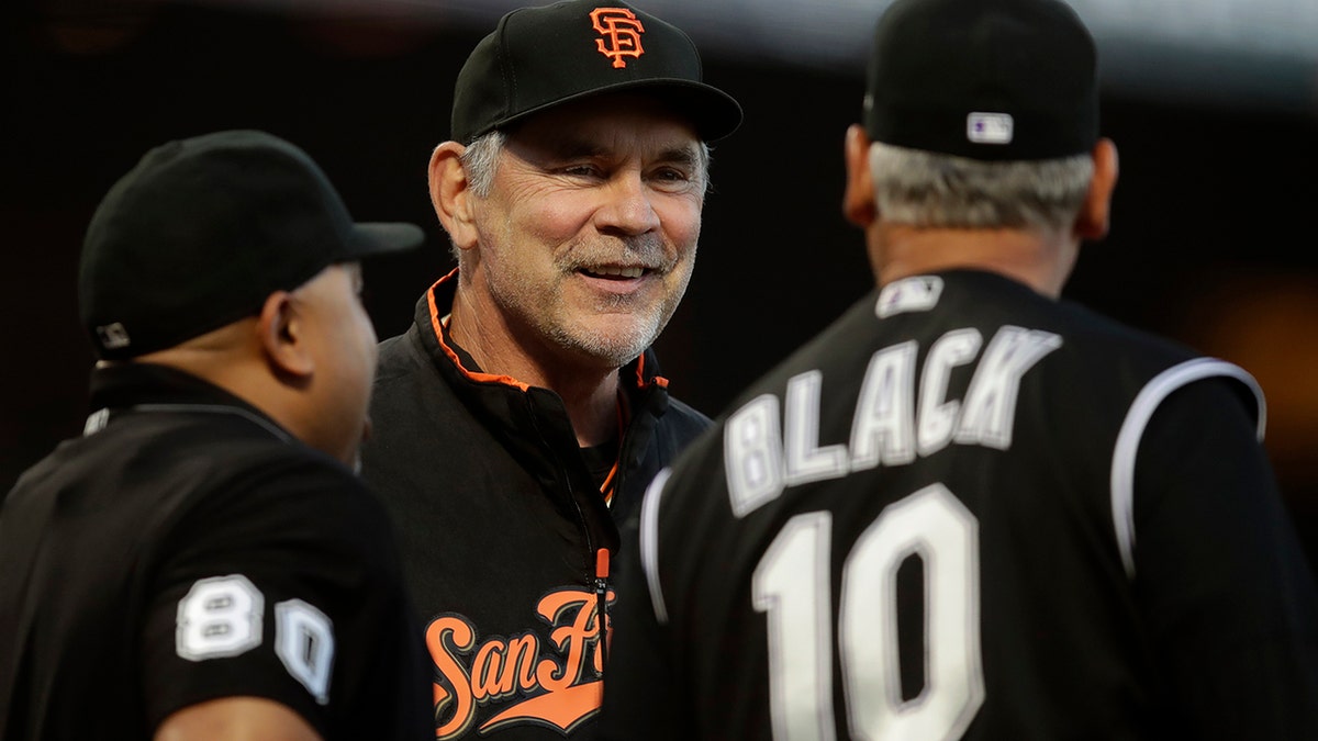 San Francisco Giants manager Bruce Bochy, center, smiles while speaking to Colorado Rockies manager Bud Black (10) prior to a baseball game Tuesday, Sept. 24, 2019, in San Francisco. (AP Photo/Ben Margot)