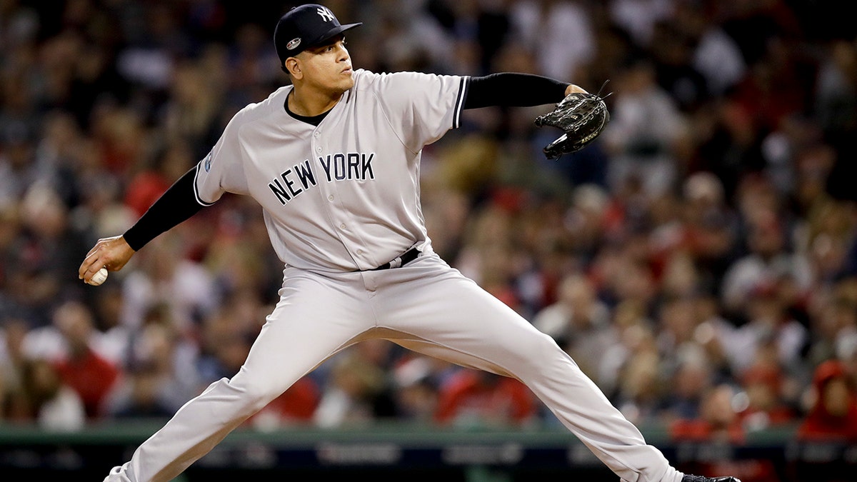 FILE - In this Oct. 6, 2018, file photo, New York Yankees relief pitcher Dellin Betances throws against the Boston Red Sox during the sixth inning of Game 2 of a baseball American League Division Series in Boston. Betances’ season appears over after just eight pitches. The Yankees say the reliever partially tore the Achilles tendon in his left foot when he hopped on the mound after striking out Brandon Drury, the second and final batter he faced in his season debut at Toronto. (AP Photo/Charles Krupa, File)