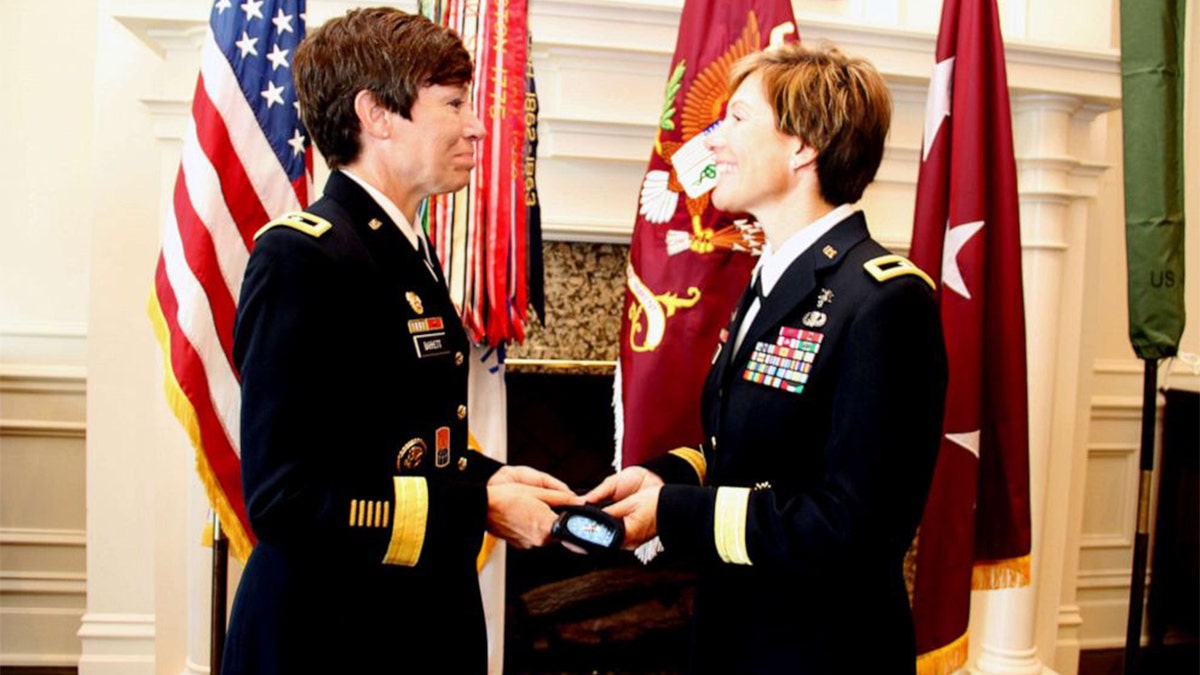 Maj. Gen. Maria Barrett presenting Brig. Gen. Paula Lodi a beret with one-star rank insignia as a tribute to the history of women serving in the Army and the historic moment of sisters serving together as General Officers.