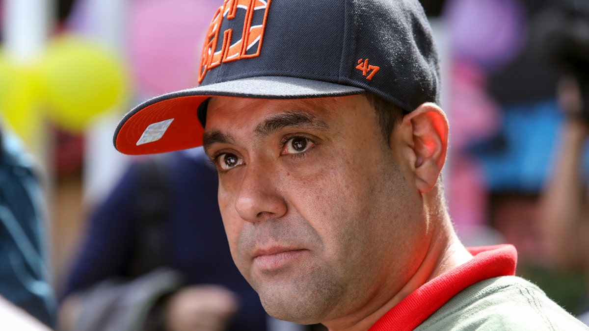 Miguel Perez Jr. listens to a supporter speaking at a news conference in Chicago on Tuesday. (AP Photo/Teresa Crawford)