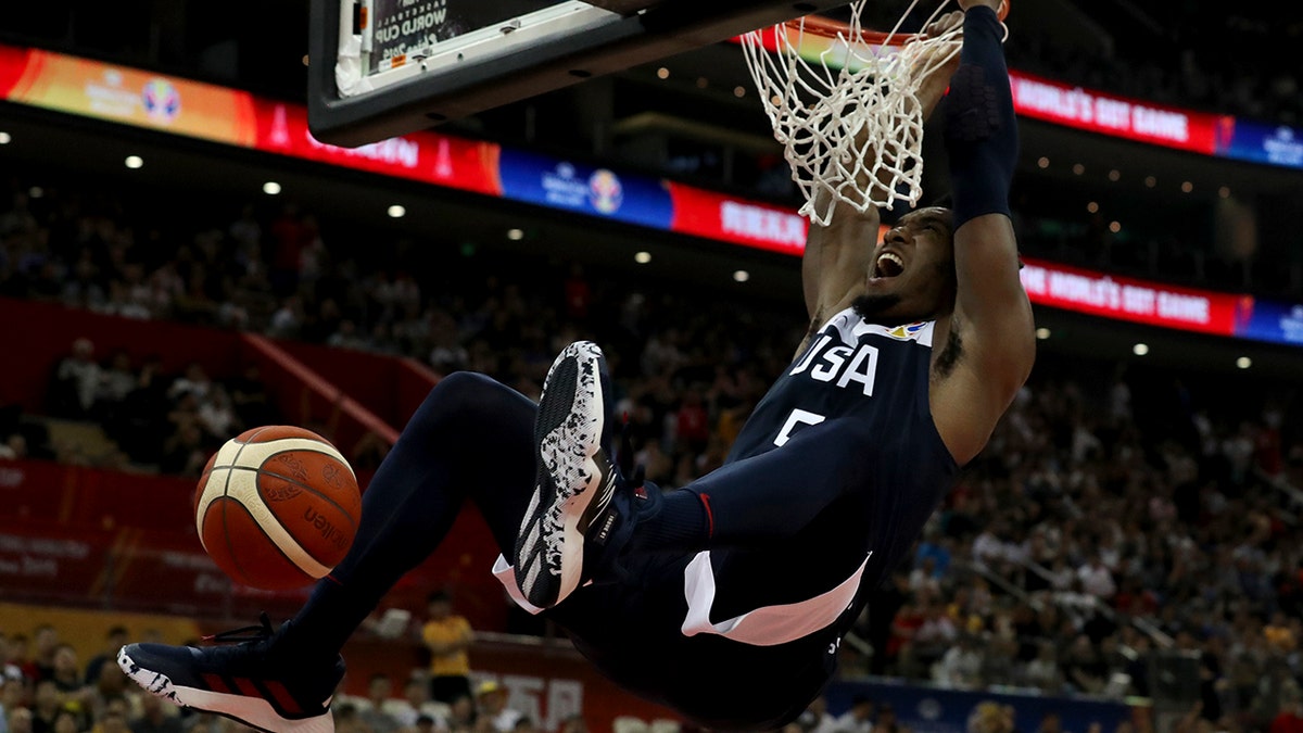 United States' Donovan Mitchell dunks during a Group E match against Czech Republic for the FIBA Basketball World Cup at the Shanghai Oriental Sports Center in Shanghai on Sunday, Sept. 1, 2019. U.S. defeats Czech Republic 88-67. (AP Photo/Ng Han Guan)