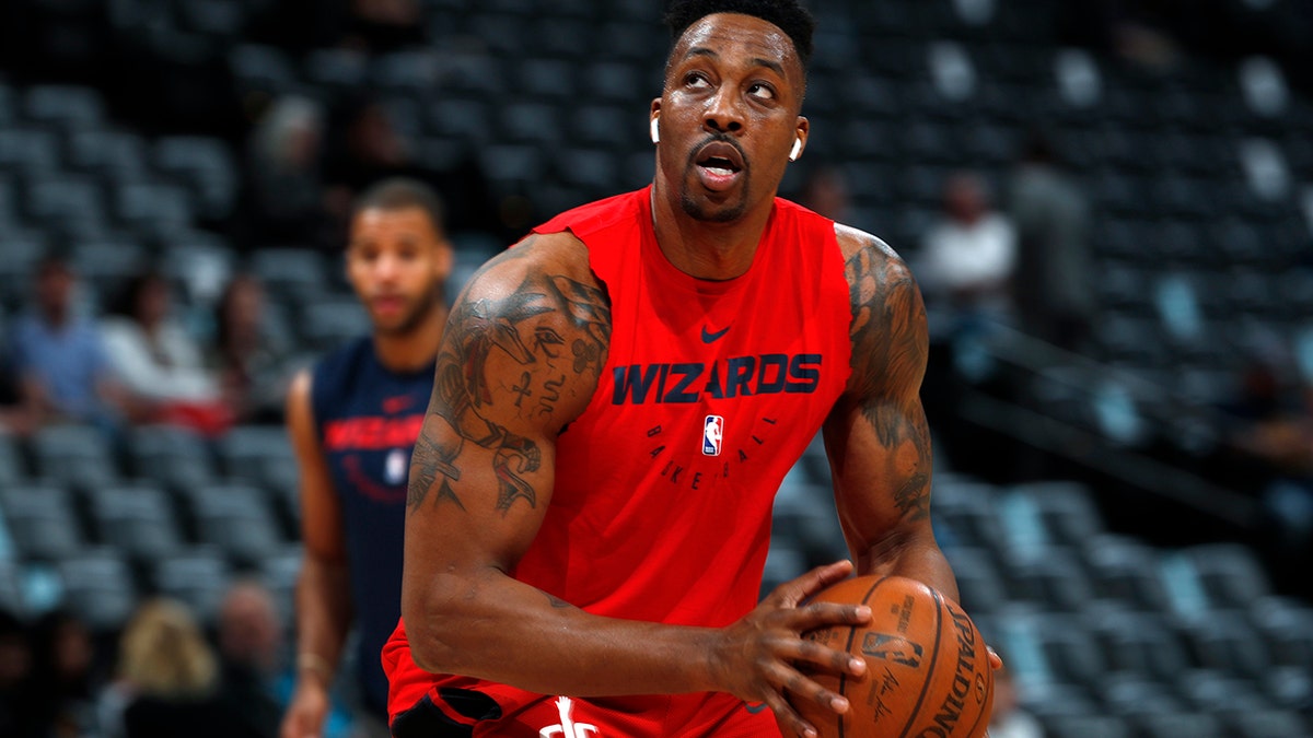 FILE - In this March 31, 2019, file photo, injured Washington Wizards center Dwight Howard practices before the Wizards face the Denver Nuggets in an NBA basketball game in Denver. Dwight Howard says he is returning to the Los Angeles Lakers with a new outlook on basketball and his place in it. Howard called it “a very big blessing” to re-sign with the Lakers, who chose him as the improbable replacement for injured center DeMarcus Cousins, Wednesday, Sept. 4, 2019. (AP Photo/David Zalubowski, File)