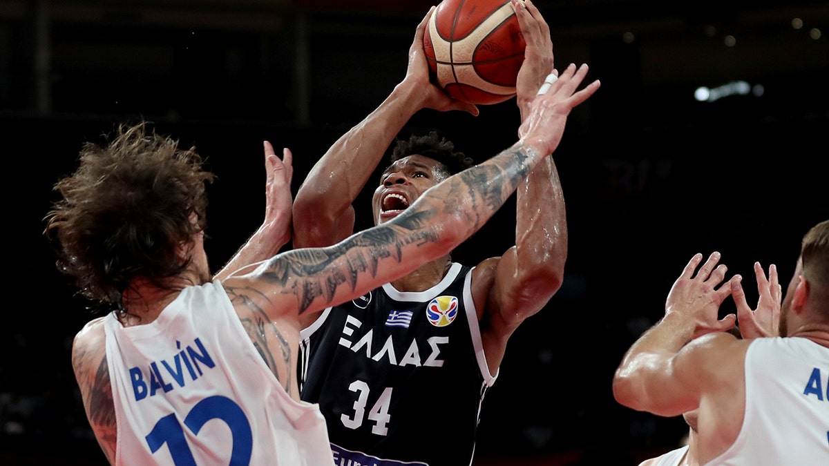 Greece's Giannis Antetokounmpo tries to shoot past Czech Republic's Ondrej Balvin during a phase two match for the FIBA Basketball World Cup at the Shenzhen Bay Sports Center in Shenzhen on Monday, Sept. 9, 2019. (AP Photo/Ng Han Guan)