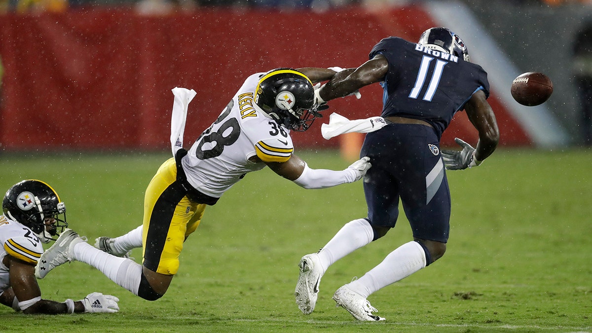 Pittsburgh Steelers defensive back Kam Kelly (38) forces a fumble by Tennessee Titans wide receiver A.J. Brown (11) in the first half of a preseason NFL football game Sunday, Aug. 25, 2019, in Nashville, Tenn. Brown recovered the ball on the play. (AP Photo/James Kenney)