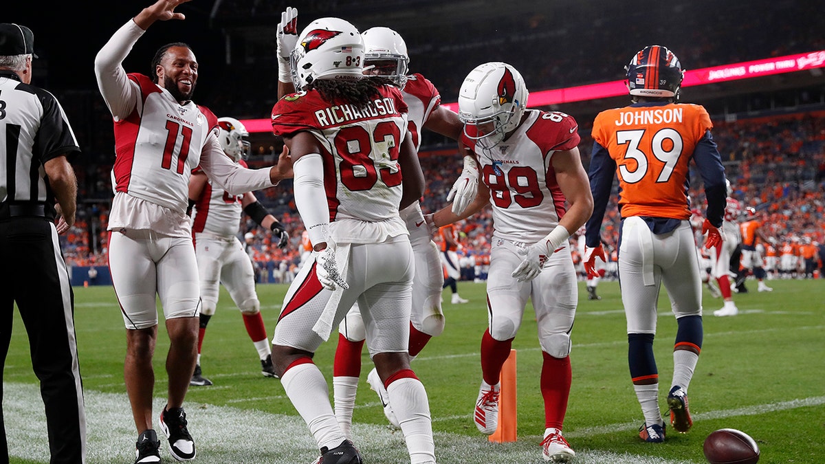 Arizona Cardinals wide receiver A.J. Richardson (83) celebrates his touchdown with wide receiver Larry Fitzgerald (11) during the second half of an NFL preseason football game against the Denver Broncos, Thursday, Aug. 29, 2019, in Denver. (AP Photo/David Zalubowski)