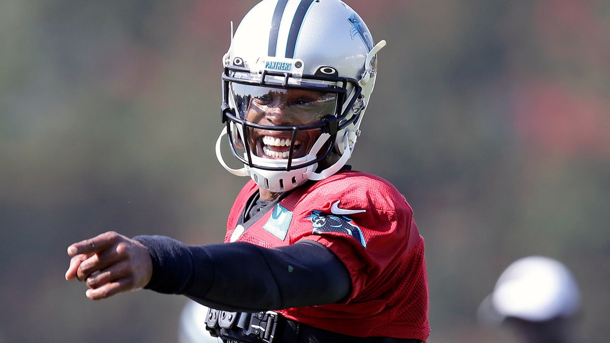 Carolina Panthers quarterback Cam Newton jokes with a player during an NFL football training camp with the Buffalo Bills on Aug. 13, 2019,?in Spartanburg, S.C. (AP Photo/Gerry Broome, File)