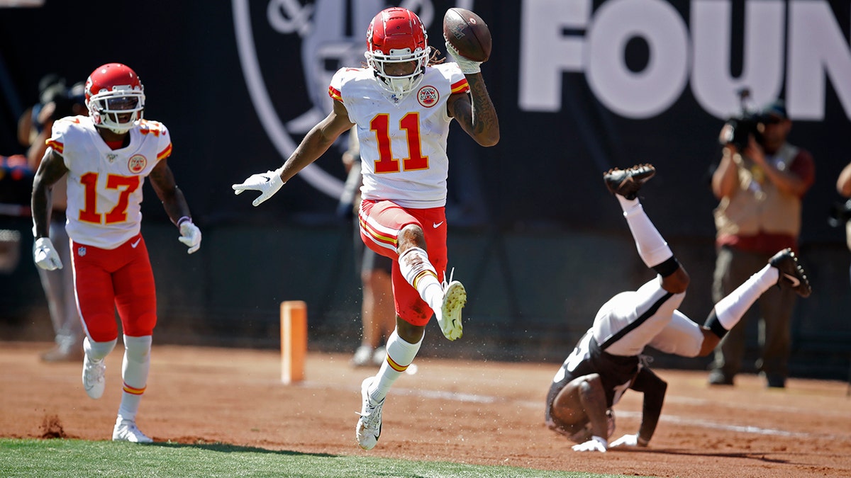 Kansas City Chiefs wide receiver Demarcus Robinson (11) celebrates after scoring a touchdown as teammate Mecole Hardman (17) looks on during the first half of an NFL football game against the Oakland Raiders Sunday, Sept. 15, 2019, in Oakland, Calif. At right is Oakland Raiders cornerback Gareon Conley. (AP Photo/Ben Margot)