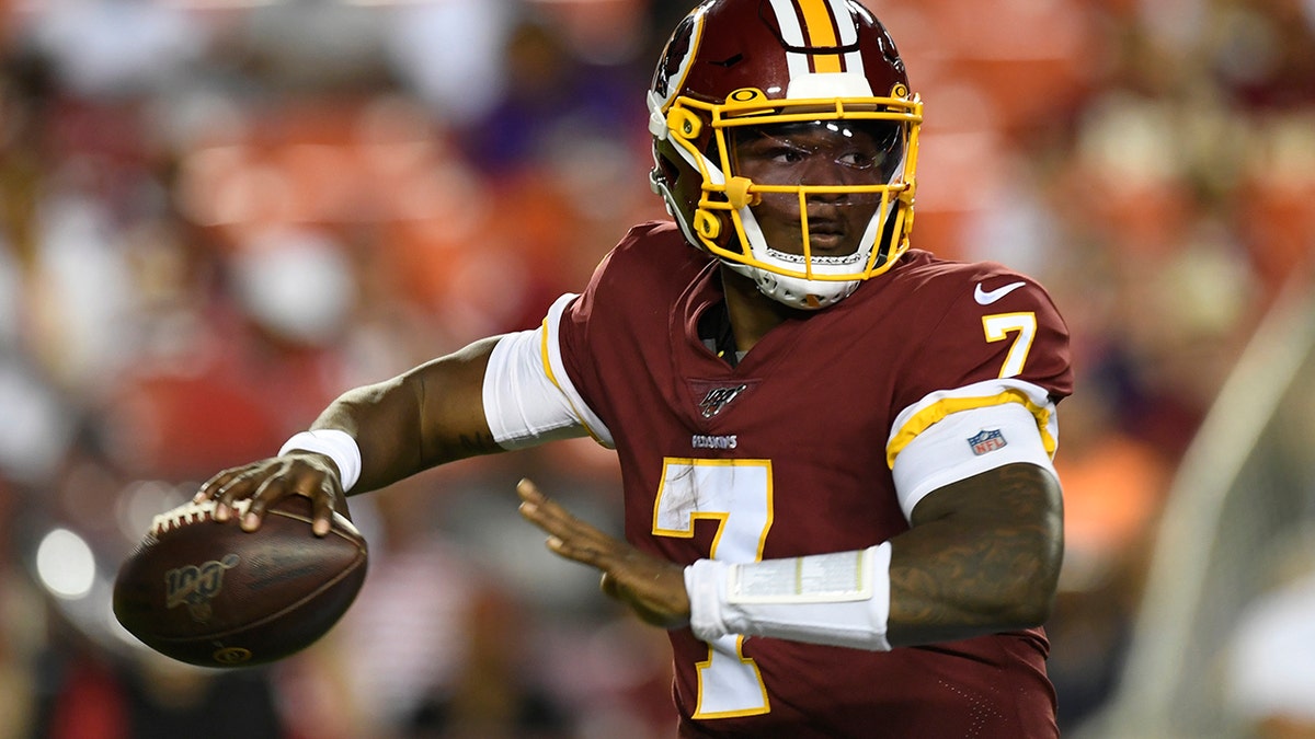 Washington Redskins quarterback Dwayne Haskins looks for an opening during the first half of an NFL preseason football game against the Baltimore Ravens at FedEx Field in Landover, Md., Thursday, Aug. 29, 2019. (AP Photo/Susan Walsh)