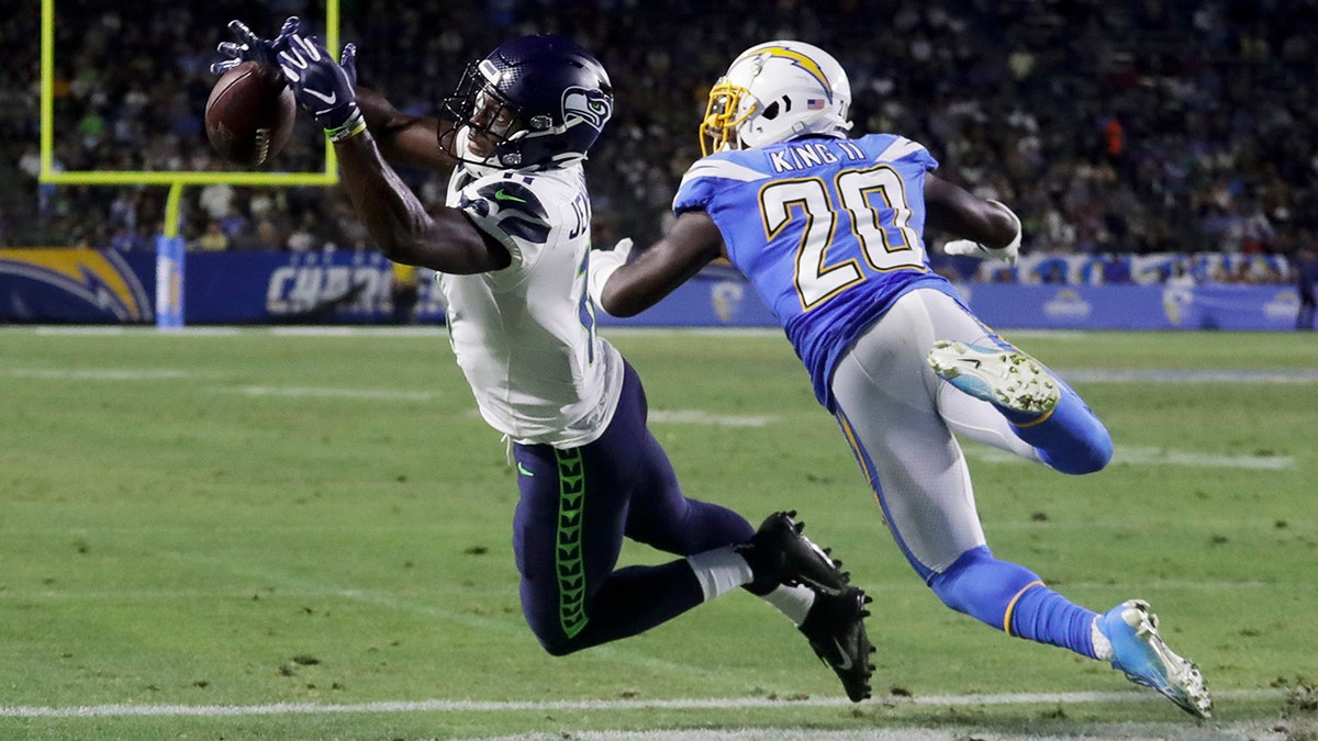 Los Angeles Chargers defensive back Desmond King, right, breaks up a pass intended for Seattle Seahawks wide receiver Gary Jennings during the second half of an NFL preseason football game Saturday, Aug. 24, 2019, in Carson, Calif. (AP Photo/Alex Gallardo)