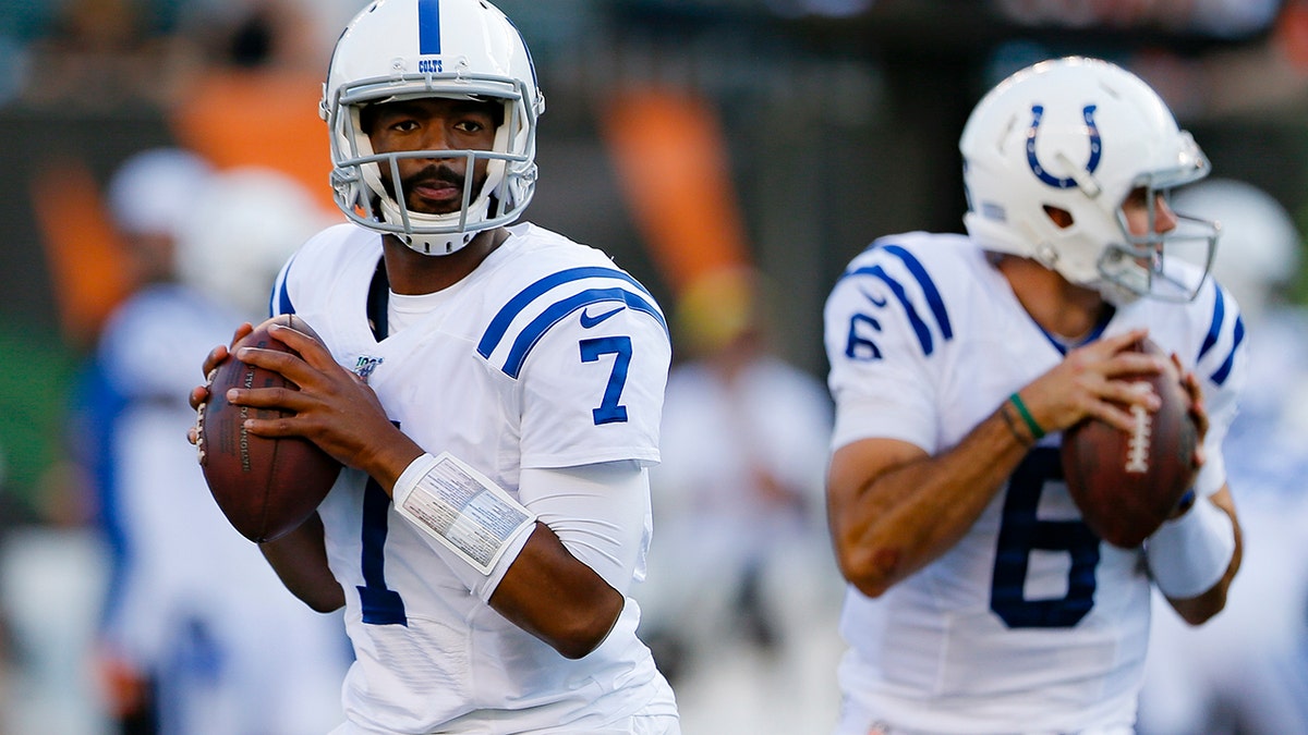 Indianapolis Colts quarterbacks Jacoby Brissett (7) and Chad Kelly warm up for the team's FL preseason football game against the Cincinnati Bengals, Thursday, Aug. 29, 2019, in Cincinnati. (AP Photo/Gary Landers)
