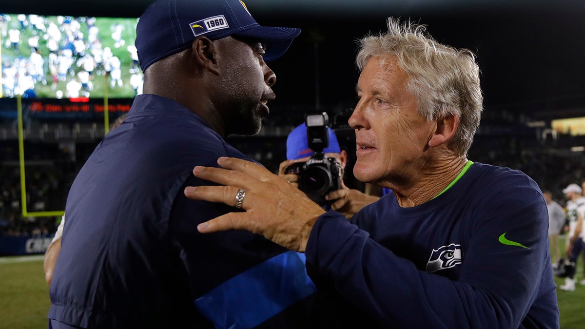 Seattle Seahawks head coach Pete Carroll, right, greets Los Angeles Chargers head coach Anthony Lynn after an NFL preseason football game Saturday, Aug. 24, 2019, in Carson, Calif. (AP Photo/Alex Gallardo)
