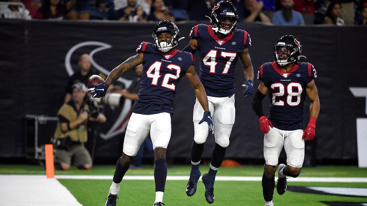 Houston Texans defensive back Jermaine Ponder (42) celebrates with Austin Exford (47) and Xavier Crawford (28) after intercepting a pass against the Los Angeles Rams during the first half of a preseason NFL football game Thursday, Aug. 29, 2019, in Houston. (AP Photo/Eric Christian Smith)