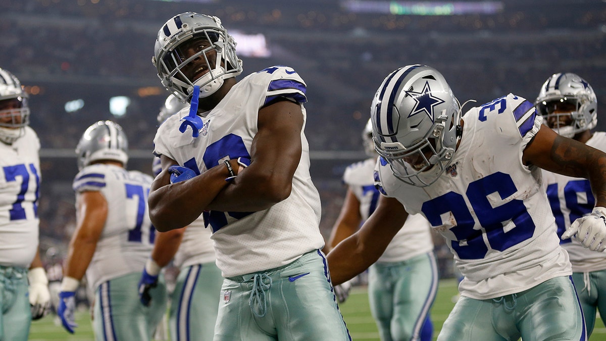 Dallas Cowboys' Michael Gallup (13) and Tony Pollard (36) celebrate a touchdown catch by Gallup in the first half of a preseason NFL football game against the Houston Texans in Arlington, Texas, Saturday, Aug. 24, 2019. (AP Photo/Ron Jenkins)
