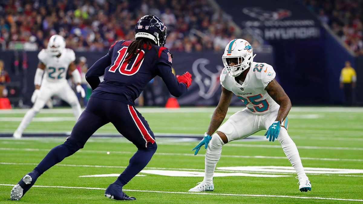 Miami Dolphins defensive back Xavien Howard (25) looks to defend against Houston Texans' DeAndre Hopkins during a 2018 NFL football game in Houston. (AP Photo/Matt Patterson, File)