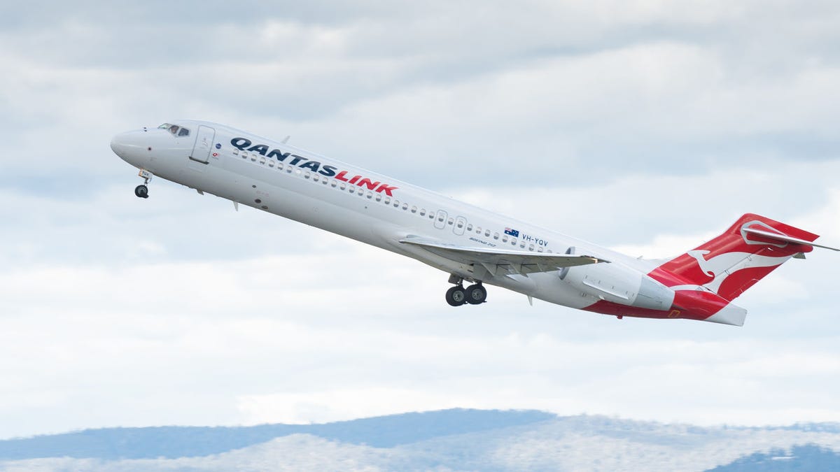 QantasLink Australia passenger airliner taking off.