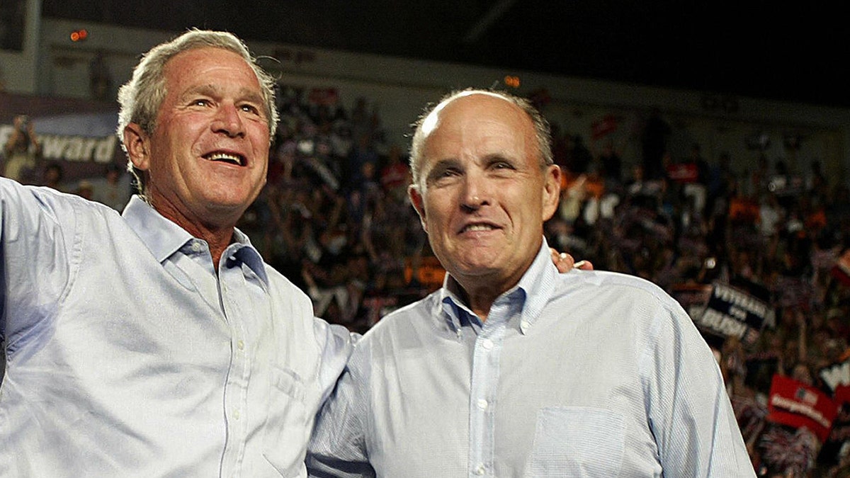 LAS CRUCES, UNITED STATES:  US President George W. Bush (L) and former Mayor of New York City Rudy Giuliani (R) attend a campaign rally 26 August 2004 at New Mexico State University in Las Cruces, New Mexico.  Bush is scheduled to make two more campaign stops in New Mexico before returning to Washington, DC later 26 August.       AFP PHOTO/Luke FRAZZA  (Photo credit should read LUKE FRAZZA/AFP/Getty Images)