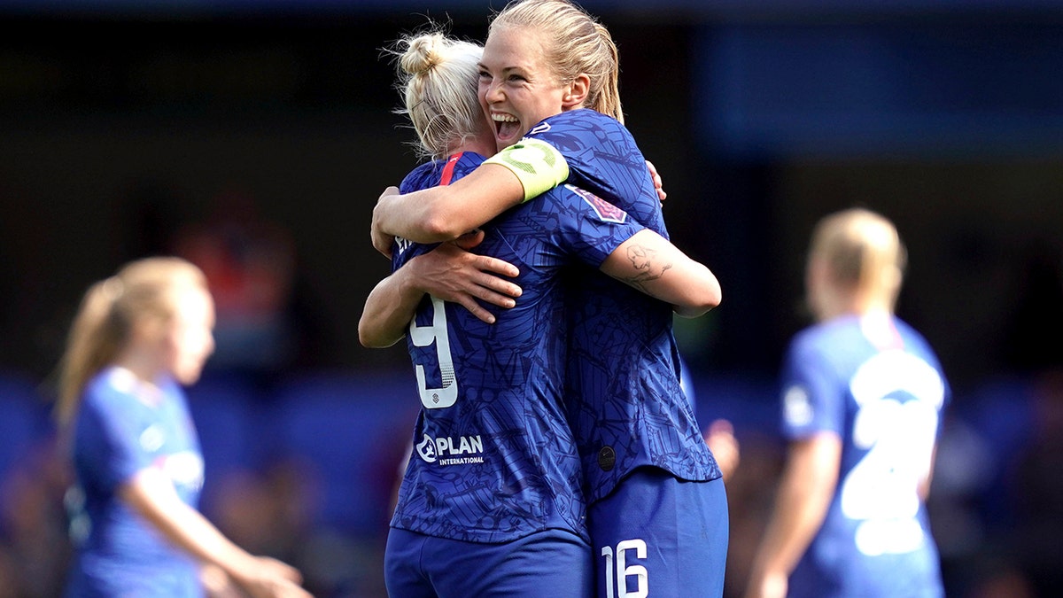 Chelsea's Bethany England, left, celebrates scoring against Tottenham Hotspur with teammate Magdalena Eriksson during the Women's Super League soccer match at Stamford Bridge, London, Sunday Sept. 8, 2019. (John Walton/PA via AP)