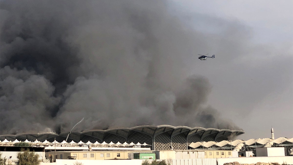 A helicopter spraying water on the fire at the Haramain high-speed rail station in Jeddah, Saudi Arabia, on Sunday.