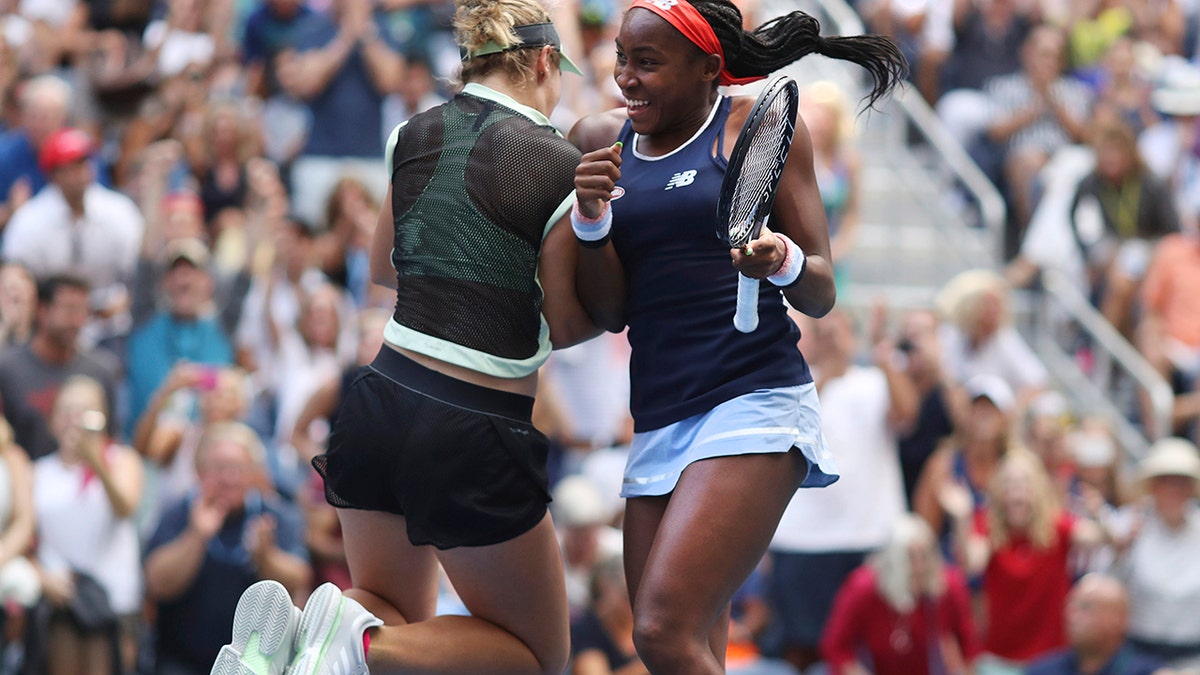 Coco Gauff, right, and her partner Catherine McNally celebrate after winning their women's doubles second round match, against Nicole Melichar and Kveta Peschjka, at the US Open tennis championships Sunday, Sept. 1, 2019, in New York. (AP Photo/Kevin Hagen)