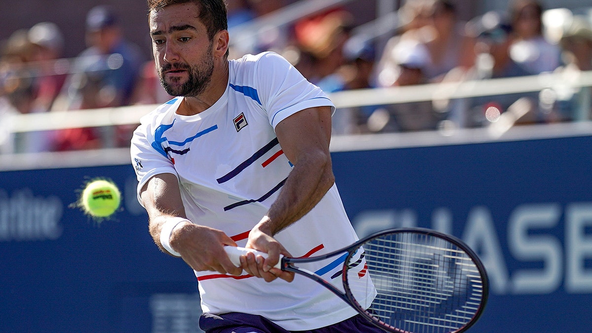 Marin Cilic, of Croatia, returns a shot to John Isner, of the United States, during round three of the US Open tennis championships Saturday, Aug. 31, 2019, in New York. (AP Photo/Michael Owens)