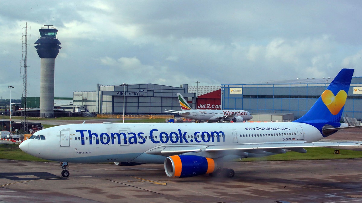 FILE - In this Aug. 13, 2019 file photo a Thomas Cook plane taxis on the runway at terminal one of Manchester Airport, England. More than 600,000 vacationers who booked through tour operator Thomas Cook were on edge Sunday, wondering if they will be able to get home, as one of the world's oldest and biggest travel companies teetered on the edge of collapse. The debt-laden company, which confirmed Friday it was seeking 200 million pounds ($250 million) in funding to avoid going bust, was in talks with shareholders and creditors to stave off failure. (Peter Byrne/PA via AP)