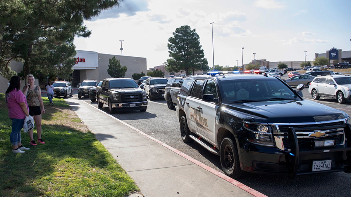 Odessa police officers parking their vehicles outside Music City Mall in Odessa, Texas, after the initial shots were fired Saturday.