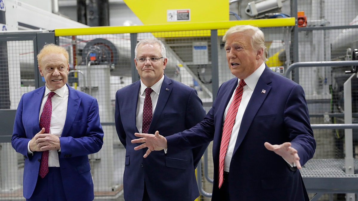 President Trump speaking as Australian Prime Minister Scott Morrison, center, and Pratt Industries chairman Anthony Pratt watched during a factory tour Sunday.