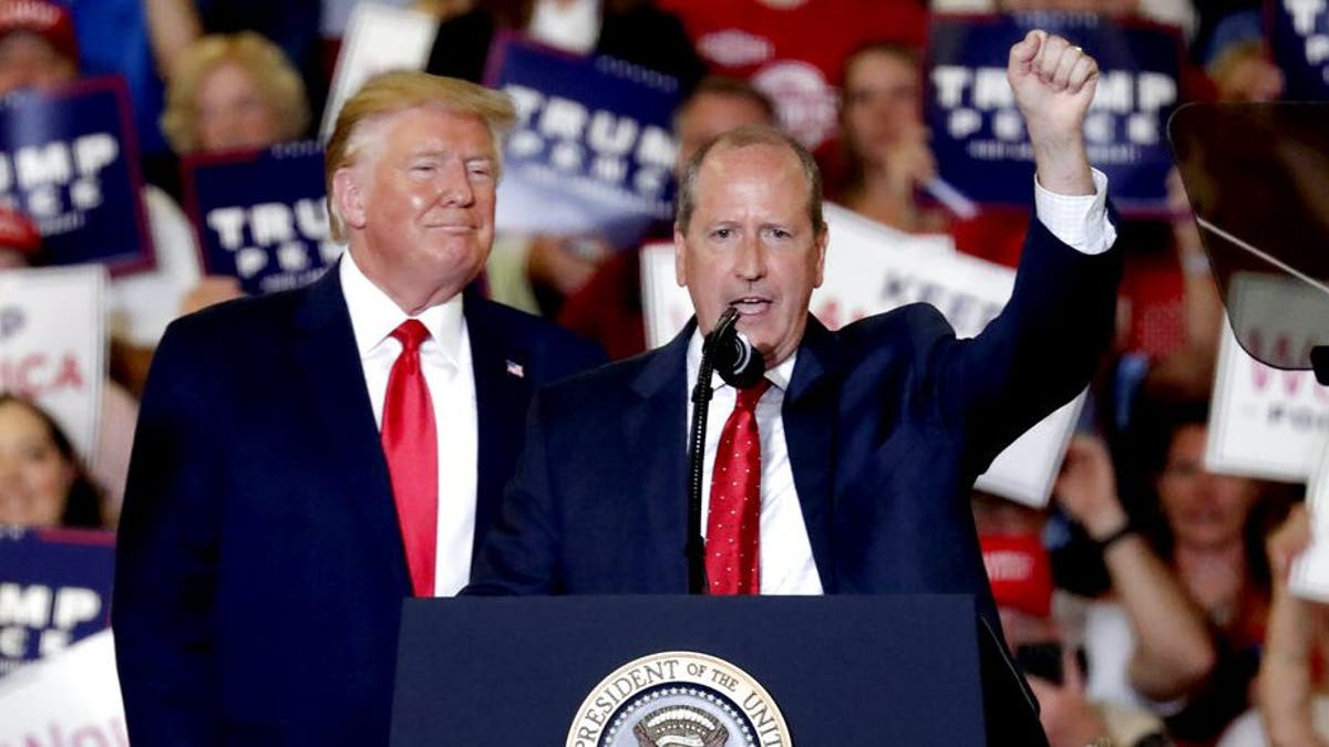 President Donald Trump, left, gives his support to Dan Bishop, right, a Republican running for the special North Carolina 9th District U.S. Congressional race as he speaks at a rally in Fayetteville, N.C., Monday, Sept. 9, 2019. (AP Photo/Chris Seward)