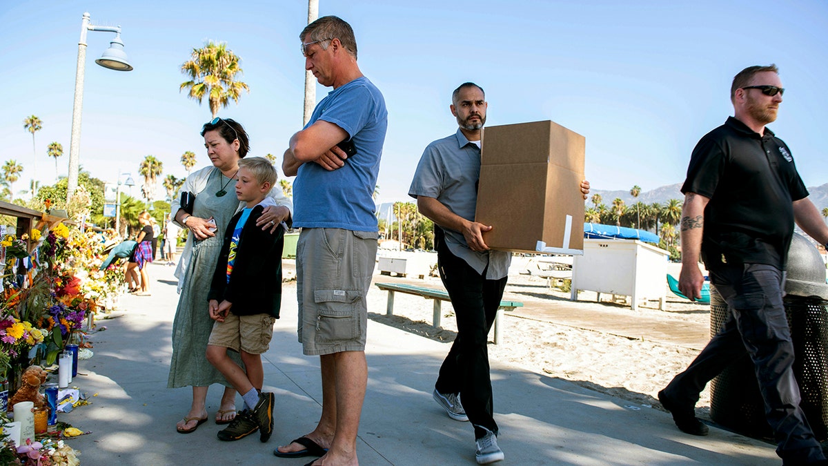 People gather around a memorial for the victims of the Conception dive boat fire on the Santa Barbara Harbor in Santa Barbara, Calif., Sunday, Sept. 8, 2019. . (AP Photo/ Christian Monterrosa)