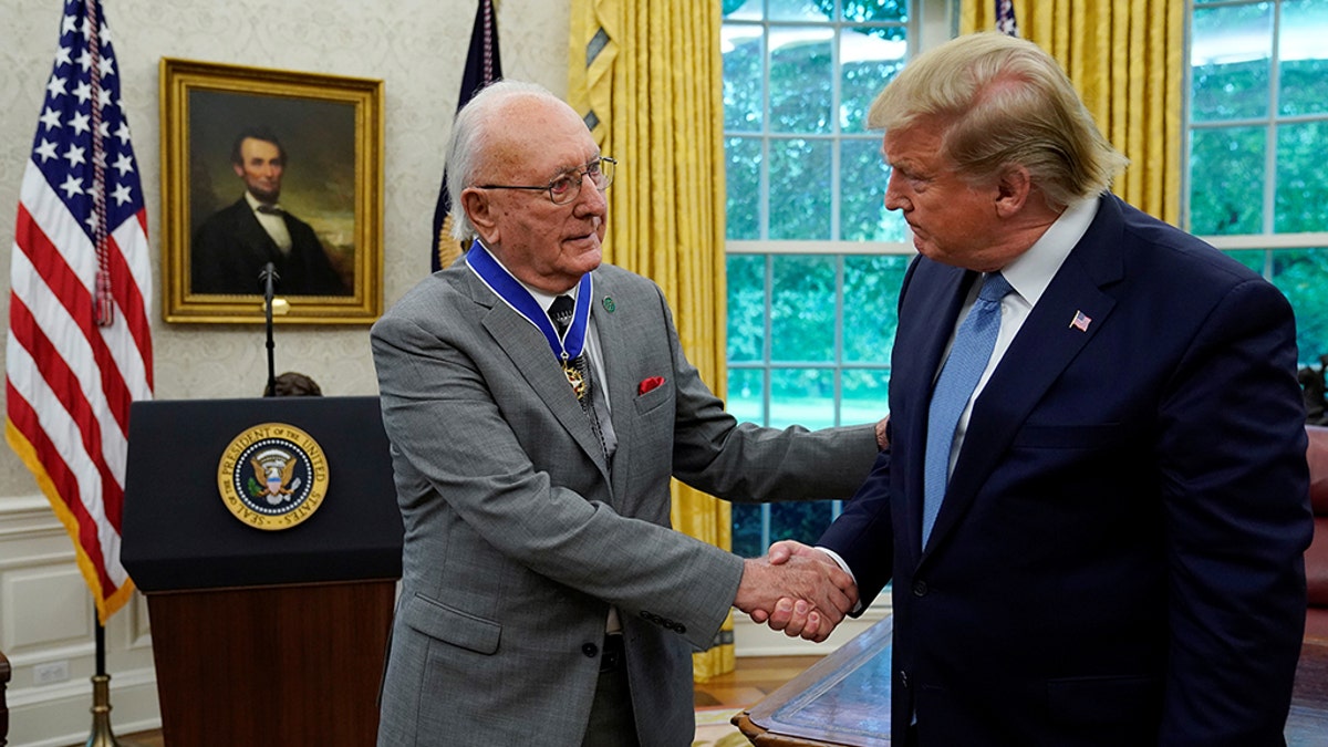 U.S. President Donald Trump greets Boston Celtics legend and Basketball Hall of Famer Bob Cousy prior to presenting Cousy with the Presidential Medal of Freedom to in the Oval Office of the White House in Washington, U.S., August 22, 2019. REUTERS/Kevin Lamarque - RC1A163A7F40