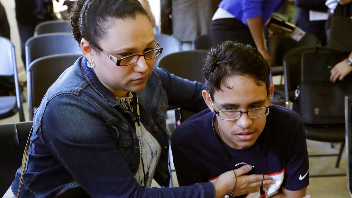 Mariela Sanchez, of Honduras, comforting her son, Jonathan, 16, during a news conference last week in Boston. The Sanchez family came to the United States seeking treatment for Jonathan's cystic fibrosis. (AP Photo/Elise Amendola)