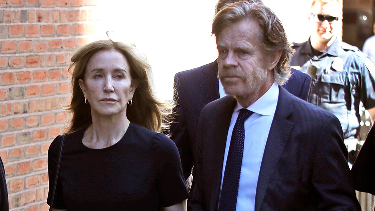 Felicity Huffman arrives at federal court with her husband William H. Macy for sentencing in a nationwide college admissions bribery scandal, Friday, Sept. 13, 2019, in Boston.