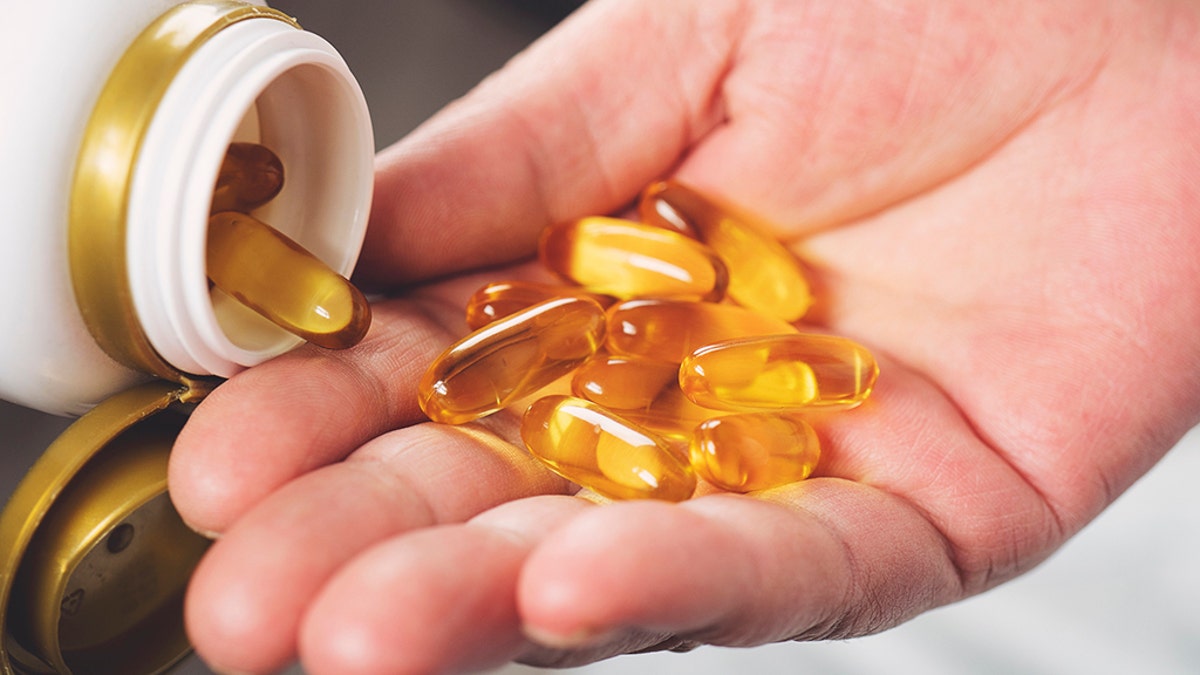 omega 3 supplements in hand
