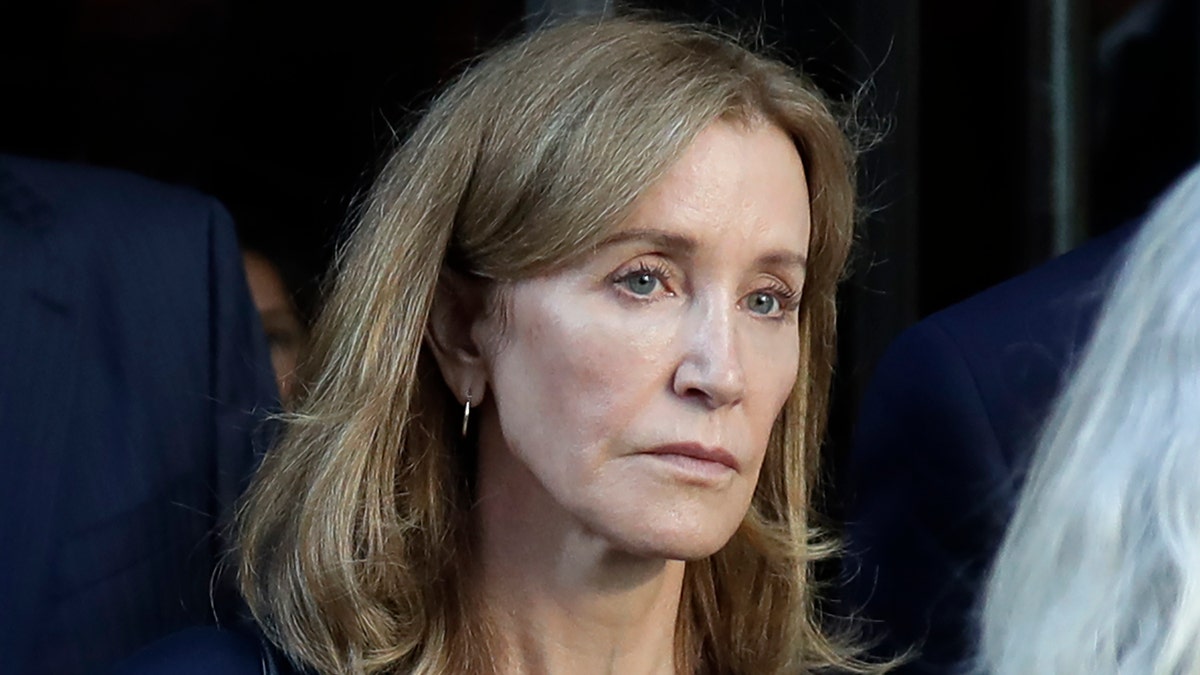 Actress Felicity Huffman leaves federal court after her sentencing in a nationwide college admissions bribery scandal, Friday, Sept. 13, 2019, in Boston. (AP Photo/Elise Amendola)