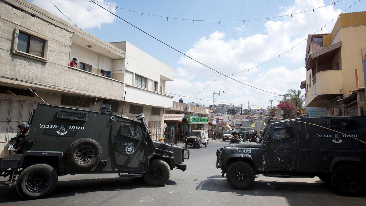 Israeli border police officers in the village of Azzun after an Israeli father and son were stabbed.?