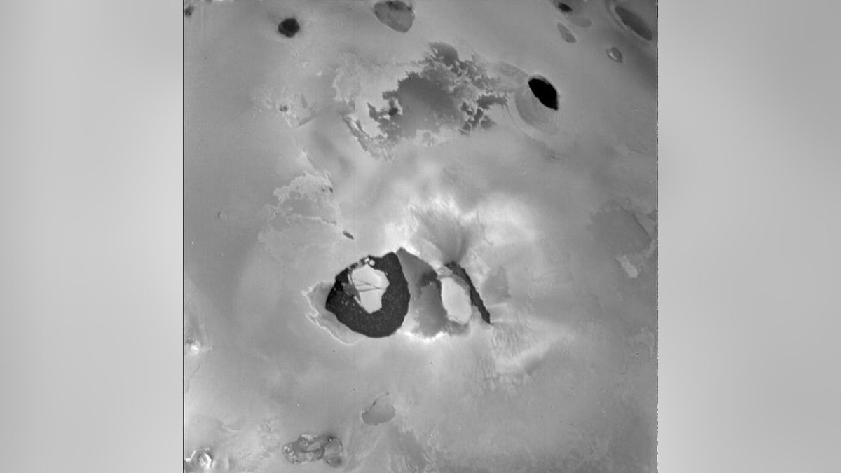 This picture from Voyager 1 shows the volcano Loki on Jupiter’s moon Io. When this picture was taken, the main eruptive activity came from the lower left of the dark linear feature (perhaps a rift) in the center. Below is the "lava lake," a U-shaped dark area about 200 kilometers across. (Credit: NASA/JPL)