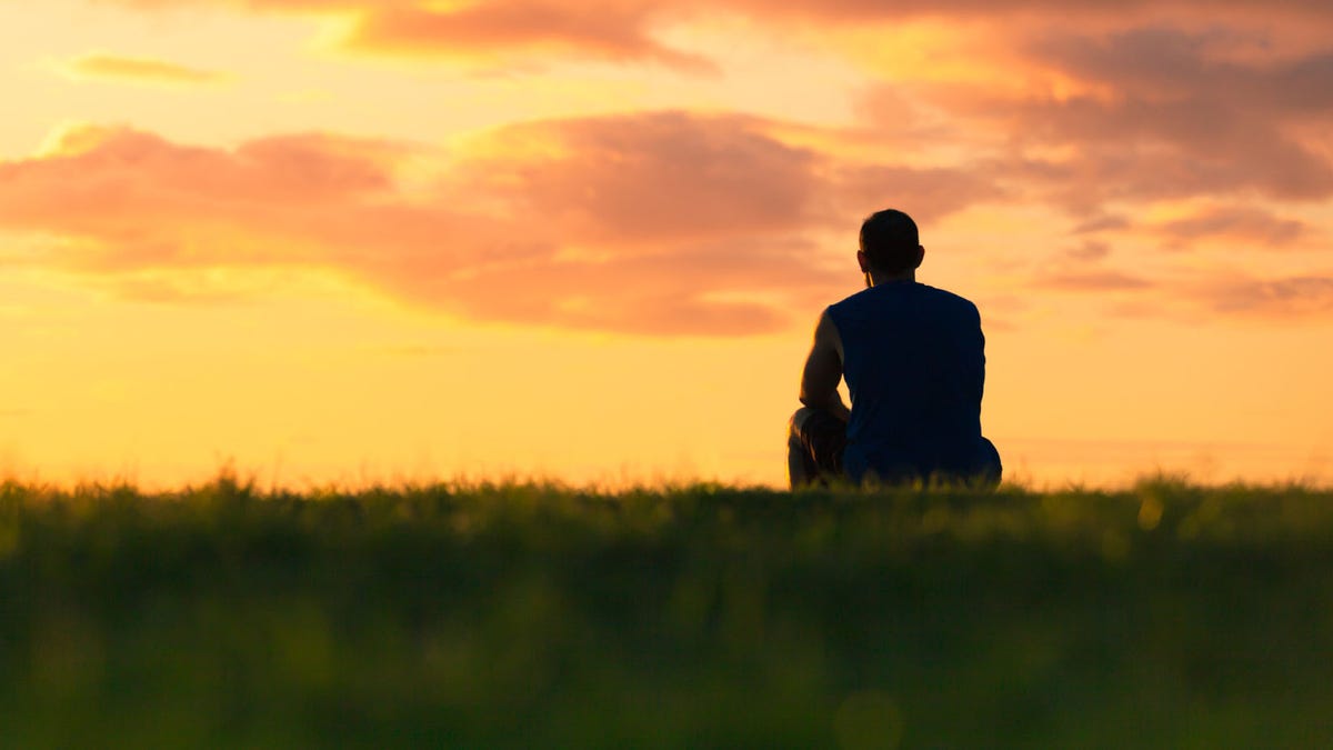 Man sitting watching sunset