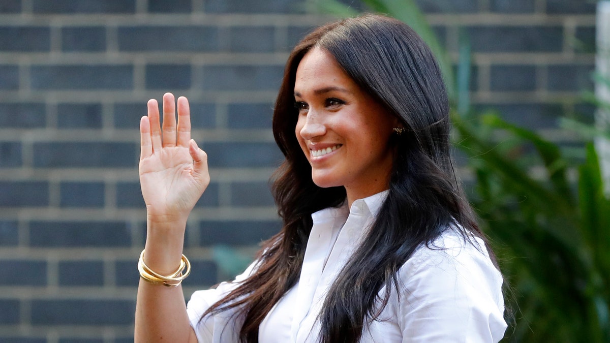 Meghan, the Duchess of Sussex, waves as she leaves a department store after launching the Smart Works capsule collection in London. 