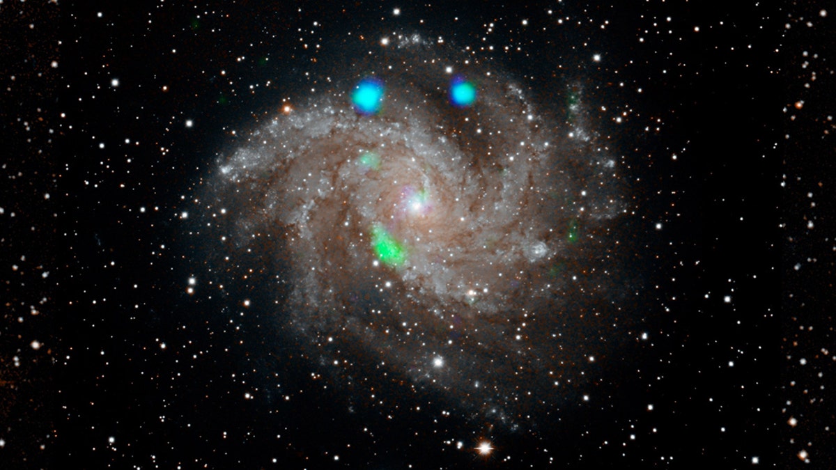 This visible-light image of the Fireworks galaxy (NGC 6946) comes from the Digital Sky Survey, and is overlaid with data from NASA's NuSTAR observatory (in blue and green). Credit: NASA/JPL-Caltech
