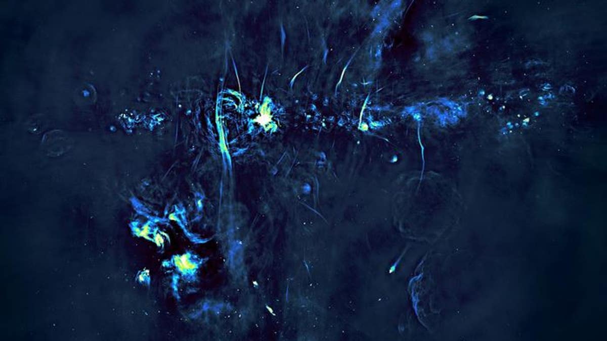 Radio image of the central portions of the Milky Way galaxy. The plane of the galaxy is marked by a series of bright features, exploded stars and regions where new stars are being born, and runs horizontally through the image.