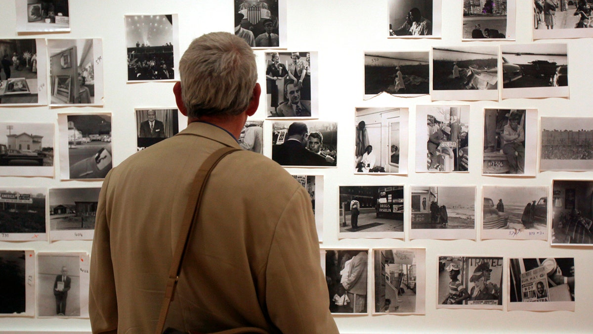 In this May 18, 2009 file photo, a man looks at prints from the Looking In: Robert Frank's "The Americans" exhibit at the Museum of Modern Art in San Francisco.?