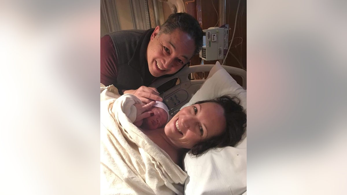 Bobby and Michele To are pictured with their son Alex, who was born in March nearly three years after his biological parents had stored their embryos. 