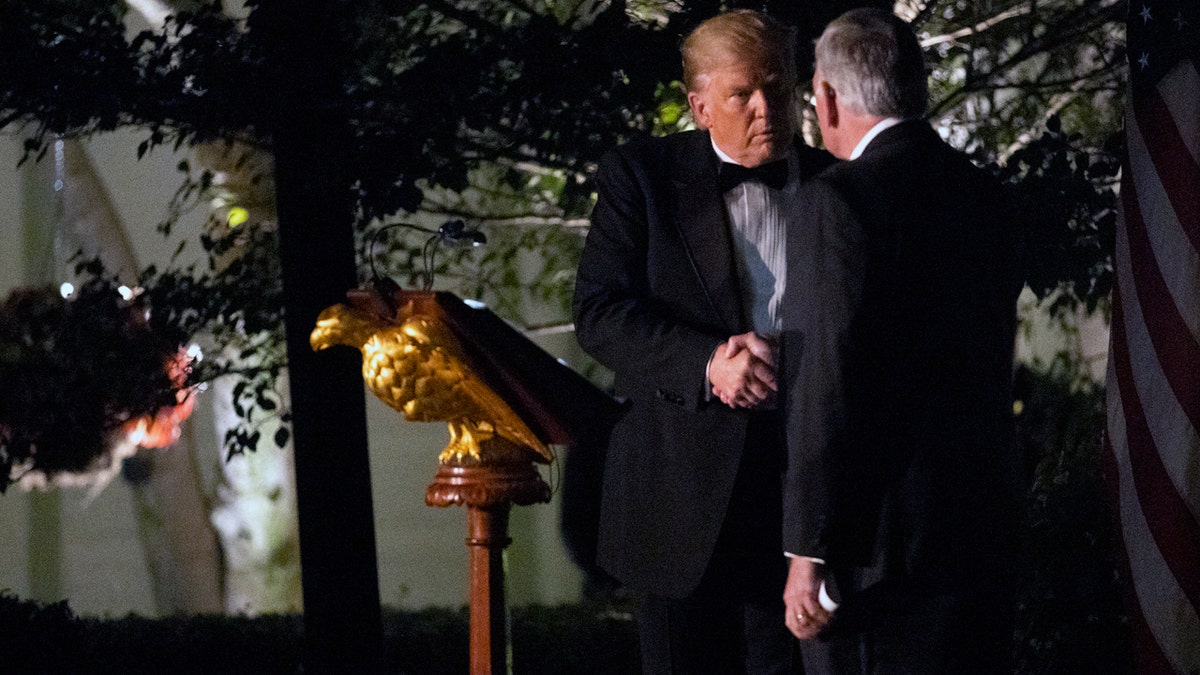 President Trump shakes hands with Australian Prime Minister Scott Morrison in the Rose Garden Friday night. (AP Photo/Jon Elswick)