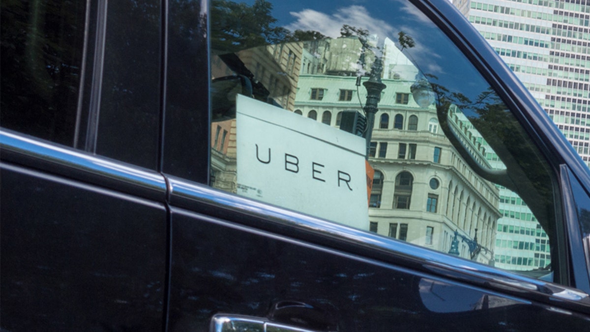New York City, USA - June 1, 2017: Close up of Uber car service sign in car window. Uber is a car service that clients call with the use of smartphone apps.