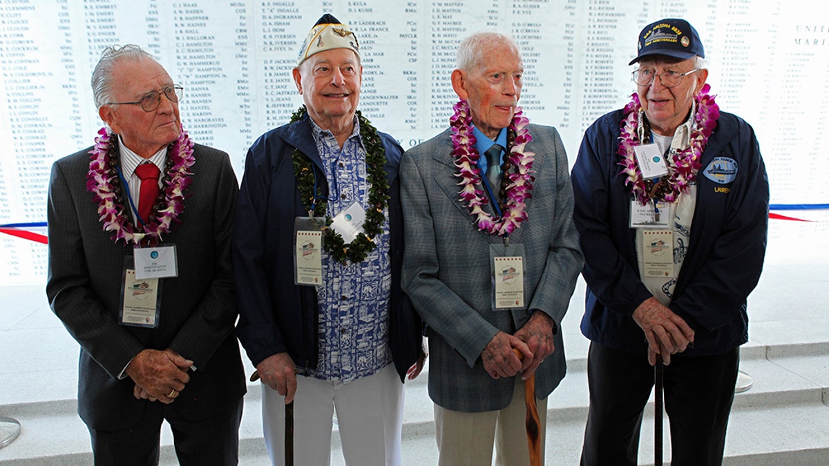 USS Arizona survivors(L to R) Donald Stratton, Louis Conter, John Anderson and Lauren Bruner pose for a picture in front of the Remembrance Wall on the USS Arizona Memorial during ceremonies honoring the 73rd anniversary of the attack on Pearl Harbor at the World War II Valor in the Pacific National Monument in Honolulu, Hawaii December 7, 2014.