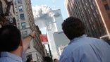 Pedestrians react to the World Trade Center collapse September 11, 2001. Two commercial airplanes crashed into the World Trade Center earlier.  REUTERS/Stringer - PBEAHUKXYAY