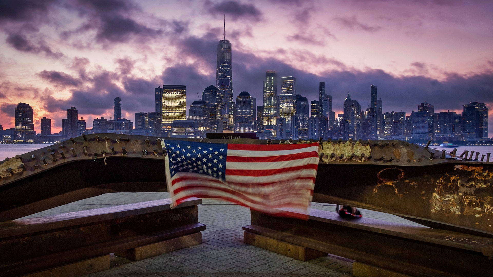 A U.S. flag hanging from a steel girder, damaged in the 9/11 attacks on the World Trade Center, blows in the breeze at a memorial in Jersey City, New Jersey, Sept. 11, 2019.