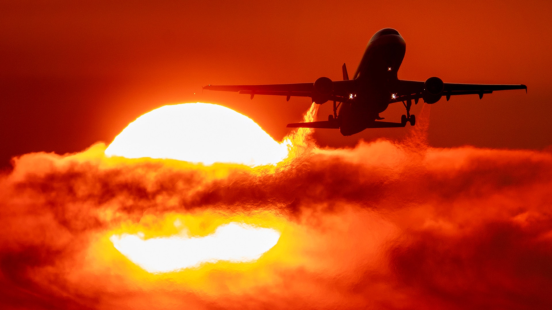An aircraft passes the rising sun as it takes off at the international airport in Frankfurt, Germany, Sept. 2, 2019. 