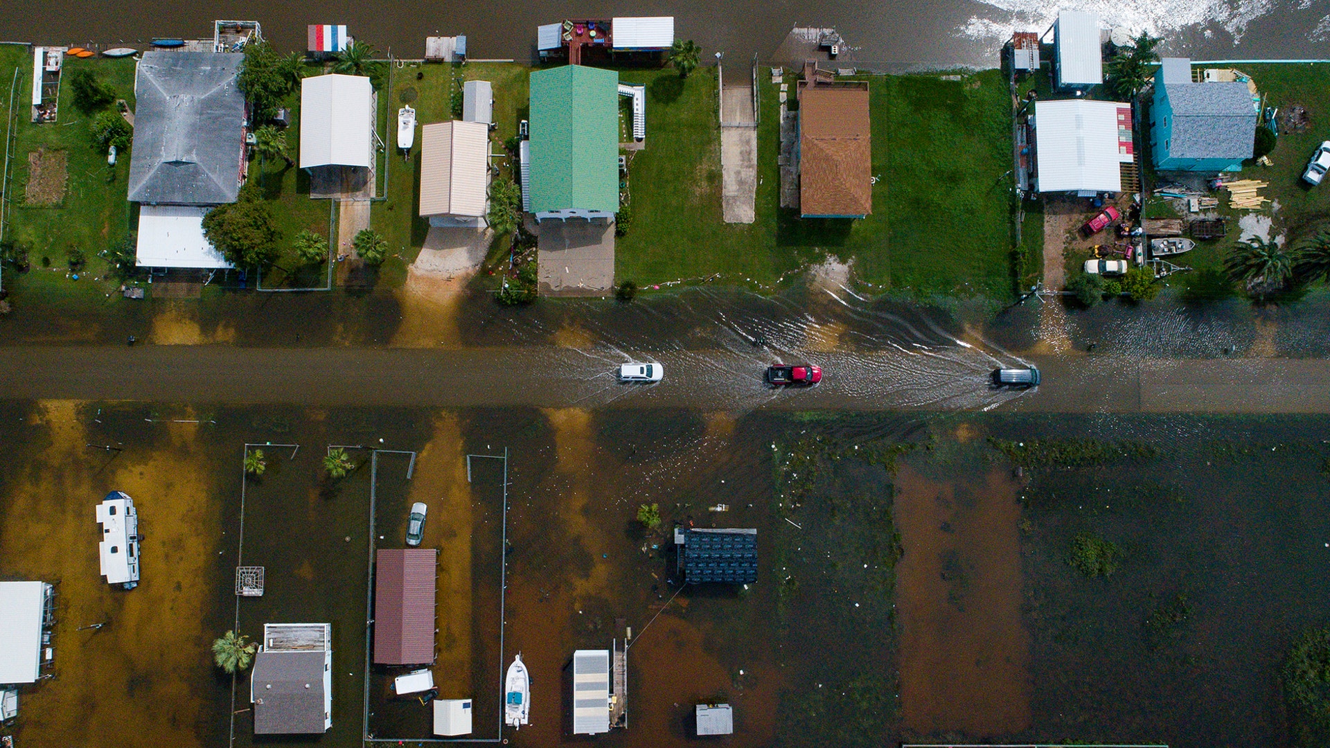 Cars drive through floodwaters from tropical storm  Imelda in Sargent, Texas, Sept. 18, 2019.