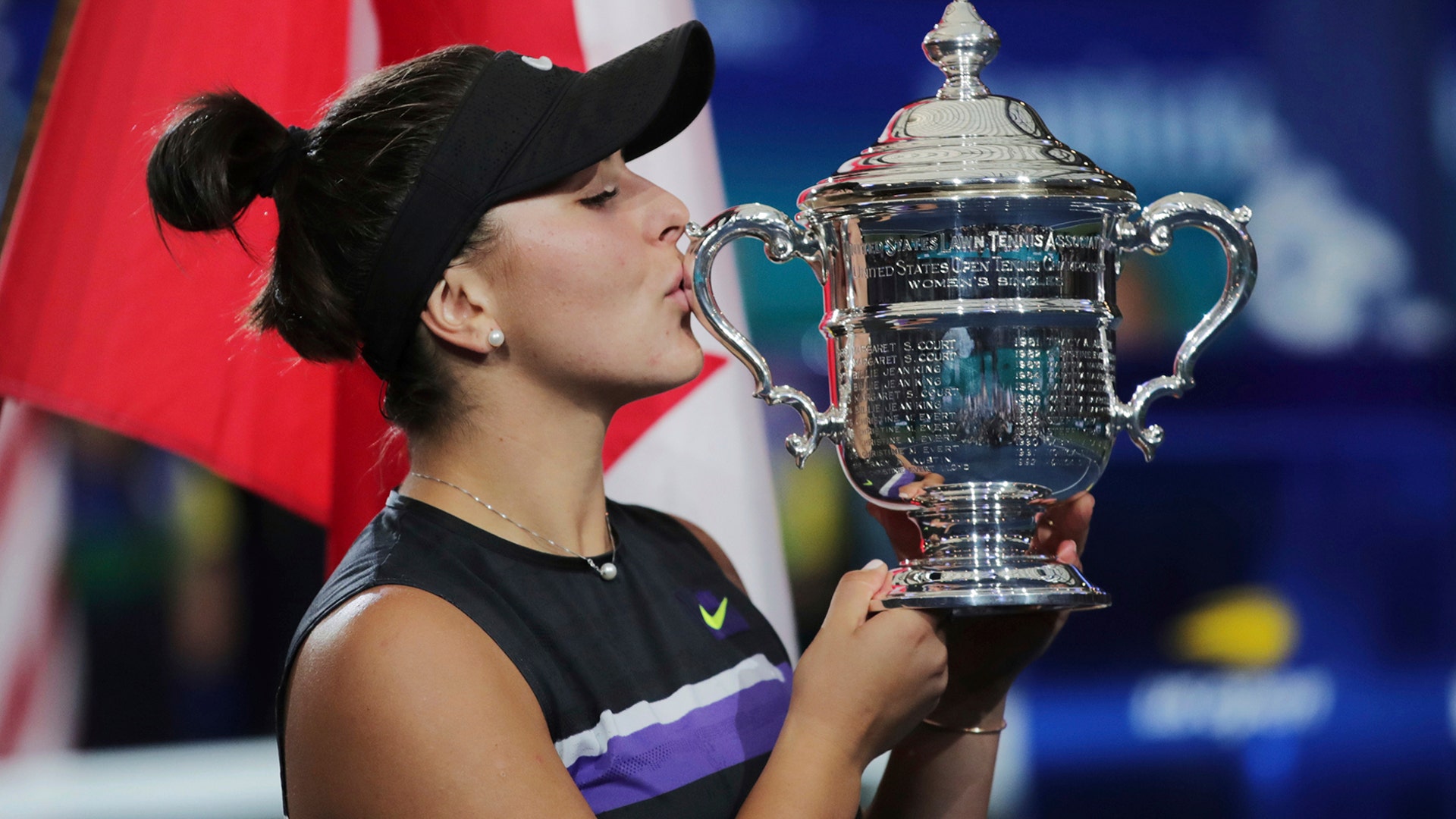 Bianca Andreescu, of Canada, kisses the championship trophy after defeating Serena Williams in the women's singles final at the U.S. Open tennis championships in New York, Sept. 7, 2019.